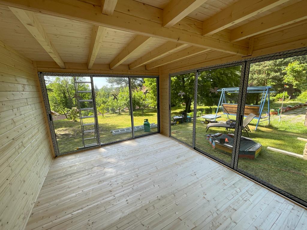 Vnútorný pohľad do dreveného záhradného ateliéru s hliníkovými oknami